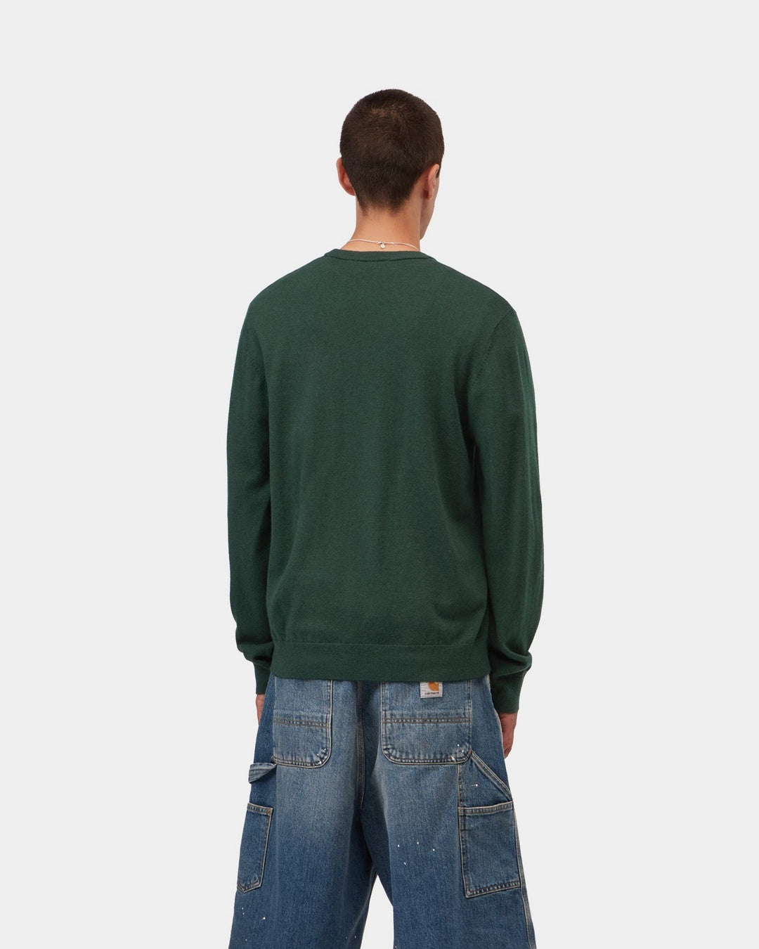 Carhartt WIP Madison Sweater in Dark Scarab / Wax, shown from the back in a dark green knit with ribbed hem and cuffs, shown on model.