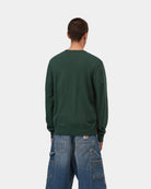 Carhartt WIP Madison Sweater in Dark Scarab / Wax, shown from the back in a dark green knit with ribbed hem and cuffs, shown on model.