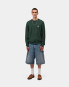Carhartt WIP Madison Sweater in Dark Scarab / Wax, shown on model with embroidered chest logo, ribbed cuffs and hem.