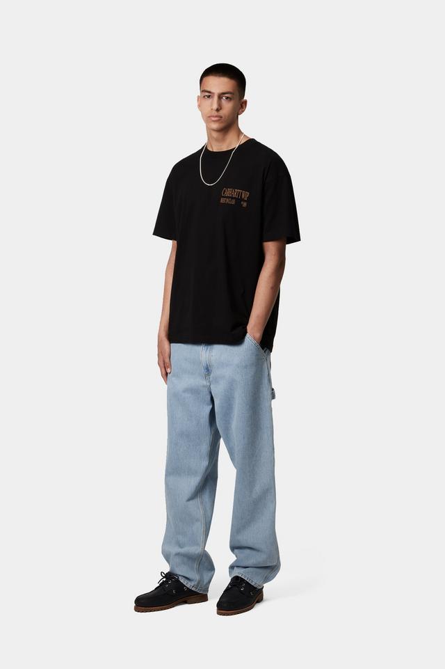 Person wearing a black t-shirt and light blue jeans on a white background