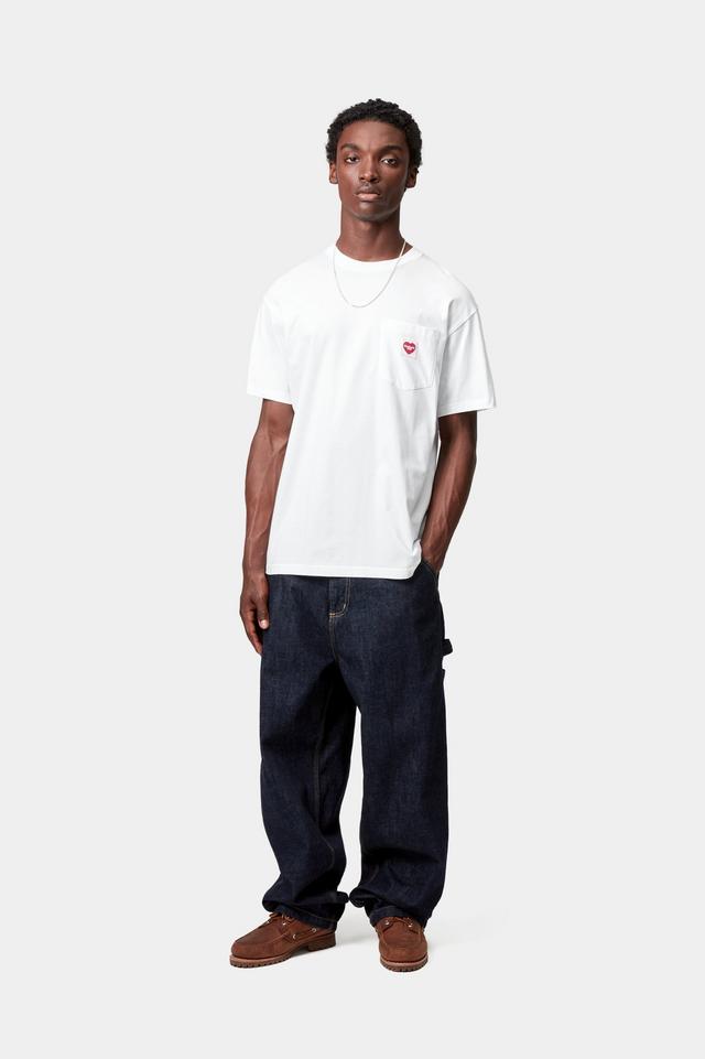 Person wearing a white t-shirt with a small red logo and dark jeans on a white background