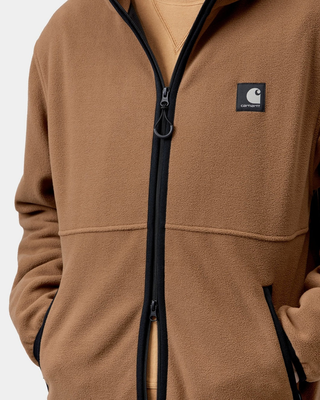 Carhartt WIP Blevin Liner in WIP H Brown, front view with full-zip closure and Square Label patch on chest, shown on model.