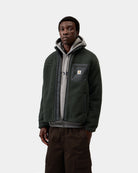 Carhartt WIP Prentis Liner in Raven / Black, front view, with a zip front, funnel neck, chest pocket, and woven logo patch, shown on model.