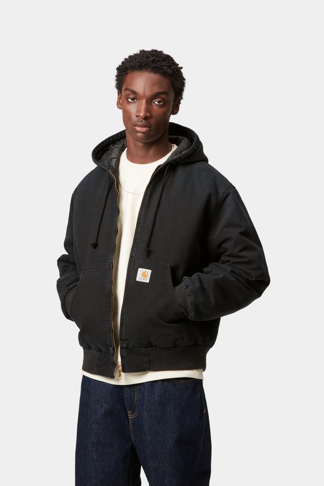 Person wearing a black hoodie jacket with a visible brand logo on a white background