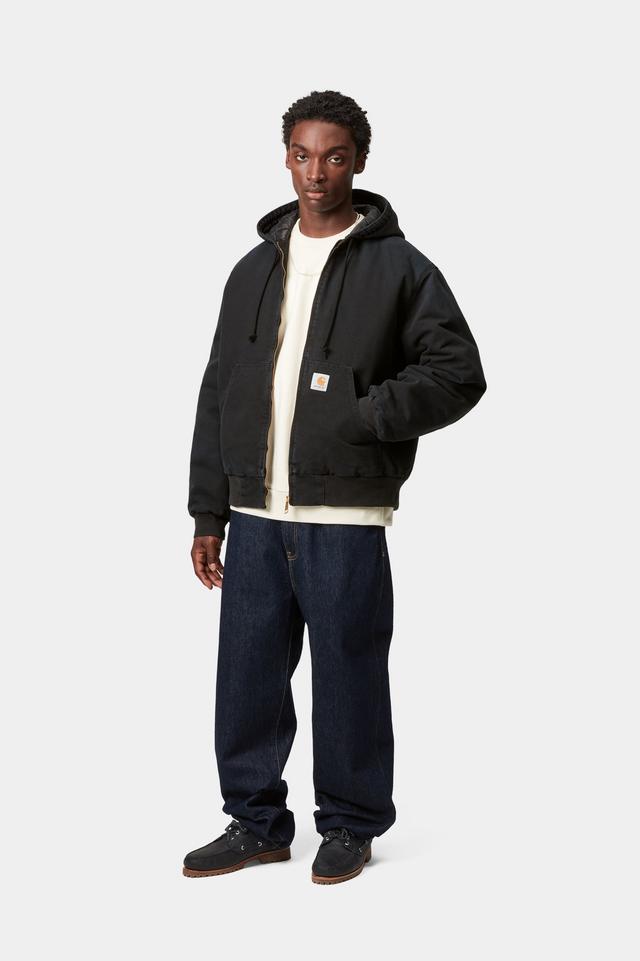 Person wearing a black jacket with a white shirt underneath on a white background