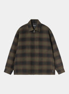 Carhartt WIP Alton Jacket in Alton Check, Cypress, front view. The jacket features a large-scale check pattern in dark green and black tones, a pointed collar, and a full-length zip closure with a silver-tone pull. A woven flag label is visible on the lower left side seam near the hem.