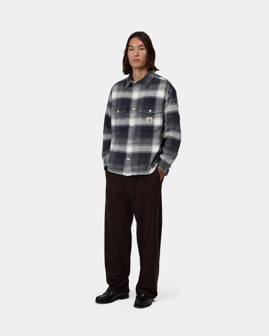 Carhartt WIP L/S Esterson Shirt in Esterson Check Dark Navy, front view, worn by model with buttoned chest pockets and Square Label.