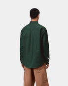 Carhartt WIP L/S OG Madison Shirt in Dark Scarab, back view, worn by model with buttoned cuffs and curved hem visible.