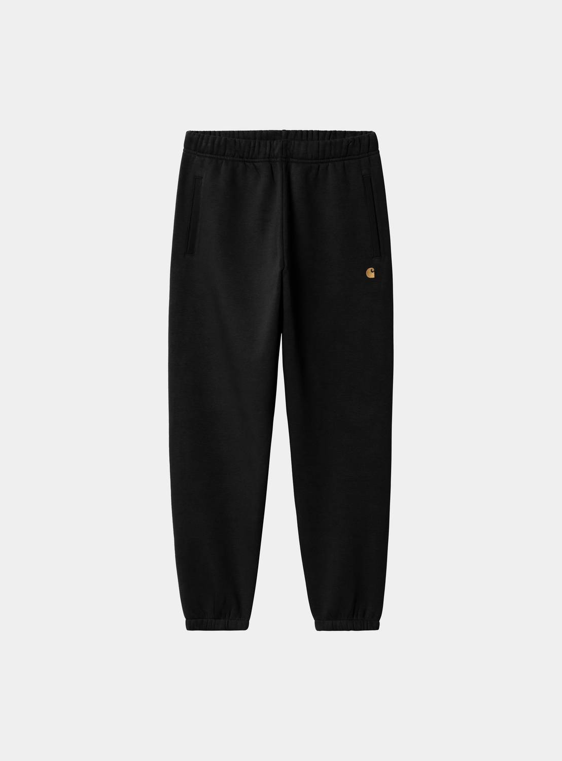 Carhartt WIP Chase Sweat Pant in Black / Gold, front view with elastic waistband, tapered legs, and small gold C logo on the thigh.