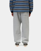 Carhartt WIP Chase Sweat Pant in Grey Heather / Gold, back view, with elasticated cuffs and a back pocket visible, shown on model.