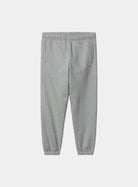 Carhartt WIP Chase Sweat Pant in Grey Heather / Gold, front view, with elastic waistband, zip pockets and embroidered logo detail on the leg.
