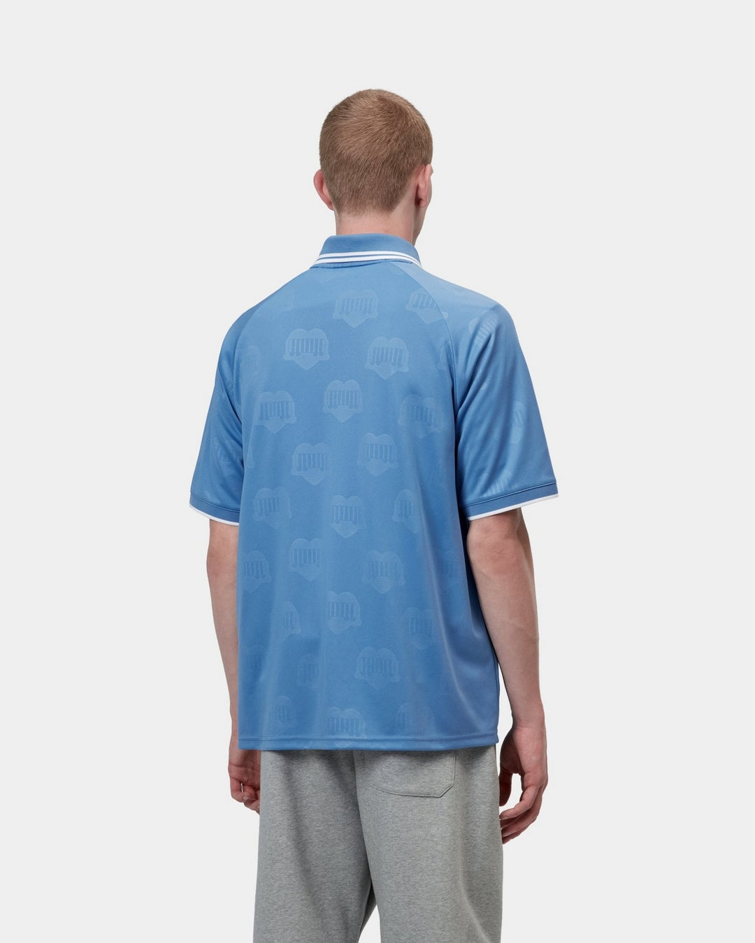 Carhartt WIP S/S Terrace Football T-Shirt in Heart Train Jacquard Curacao, back view, with allover jacquard motif and contrast striped collar and sleeve trims.