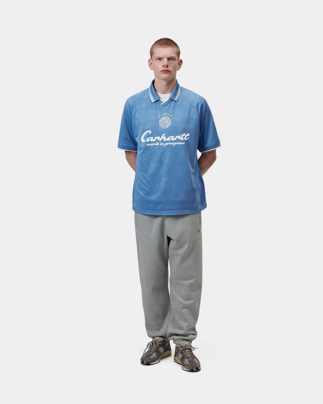 Carhartt WIP S/S Terrace Football T-Shirt in Curacao, front view, worn by model with contrast collar and sleeve trims, Carhartt WIP logo graphic on chest.