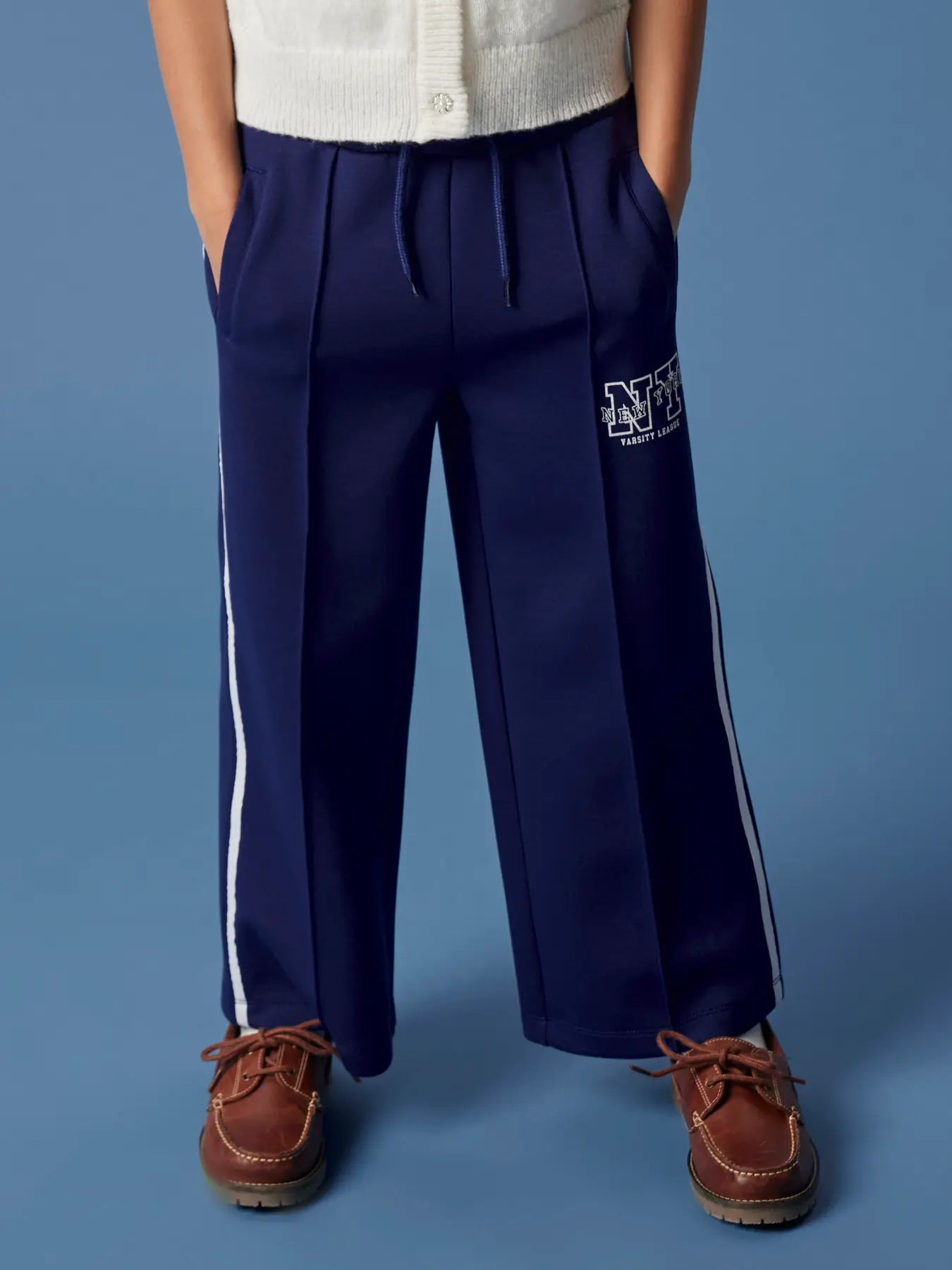 Navy blue pants with a logo on a blue background