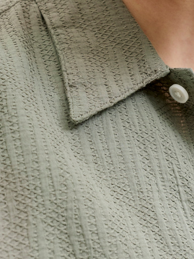 Close-up of montauk wavy texture short sleeve vetiver shirt with a button