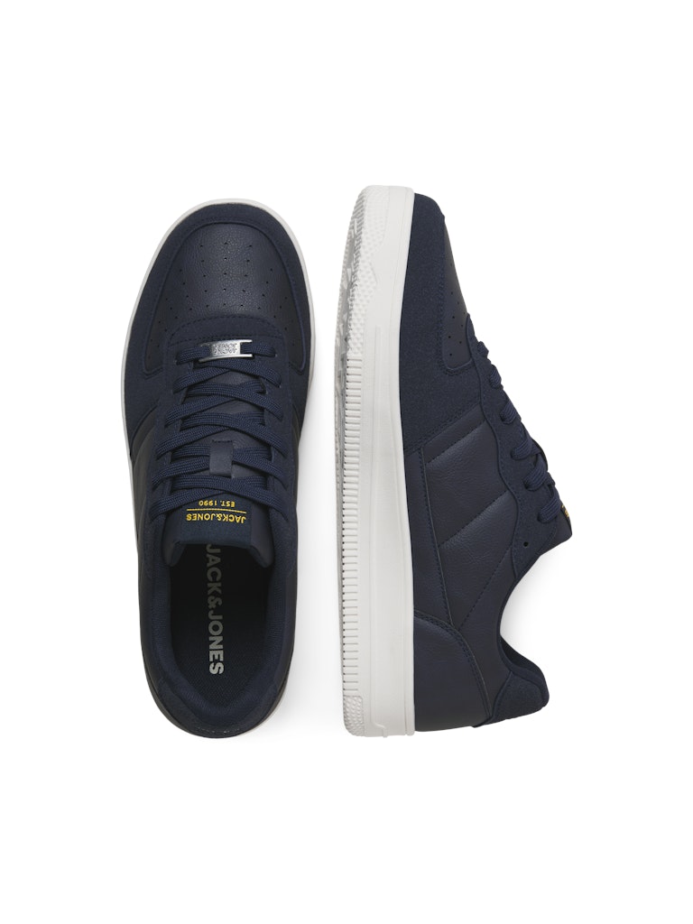 Navy blue sneakers with white soles on a white background