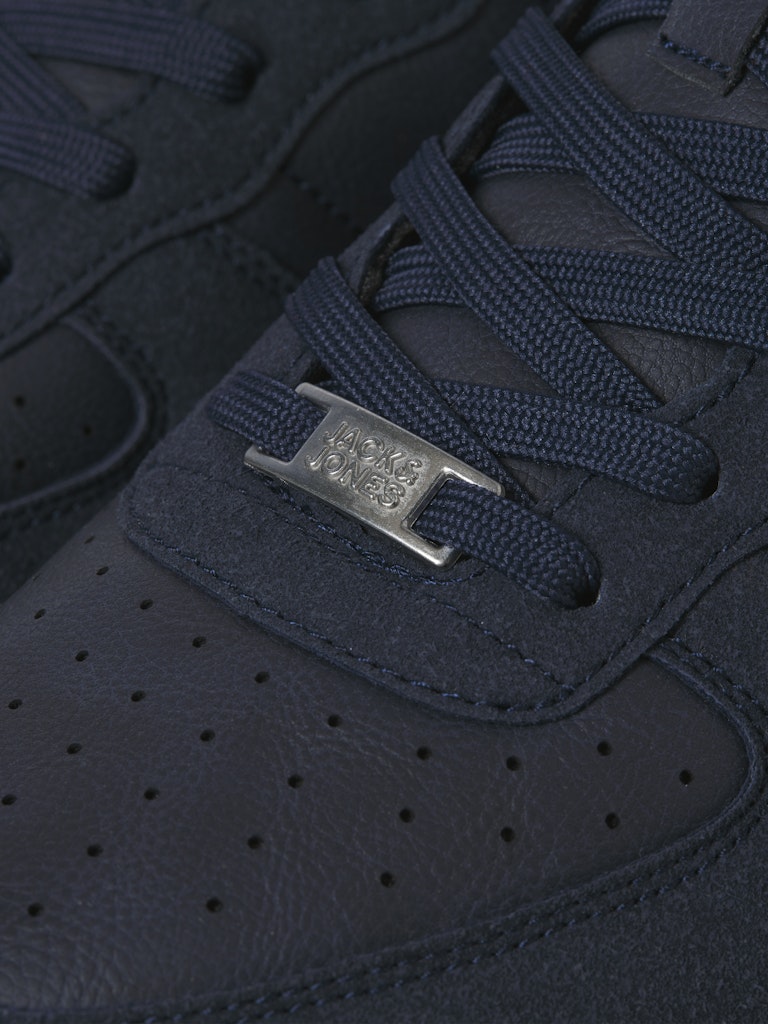 Close-up of a navy blue sneaker with a Jack & Jones brand logo on the side.