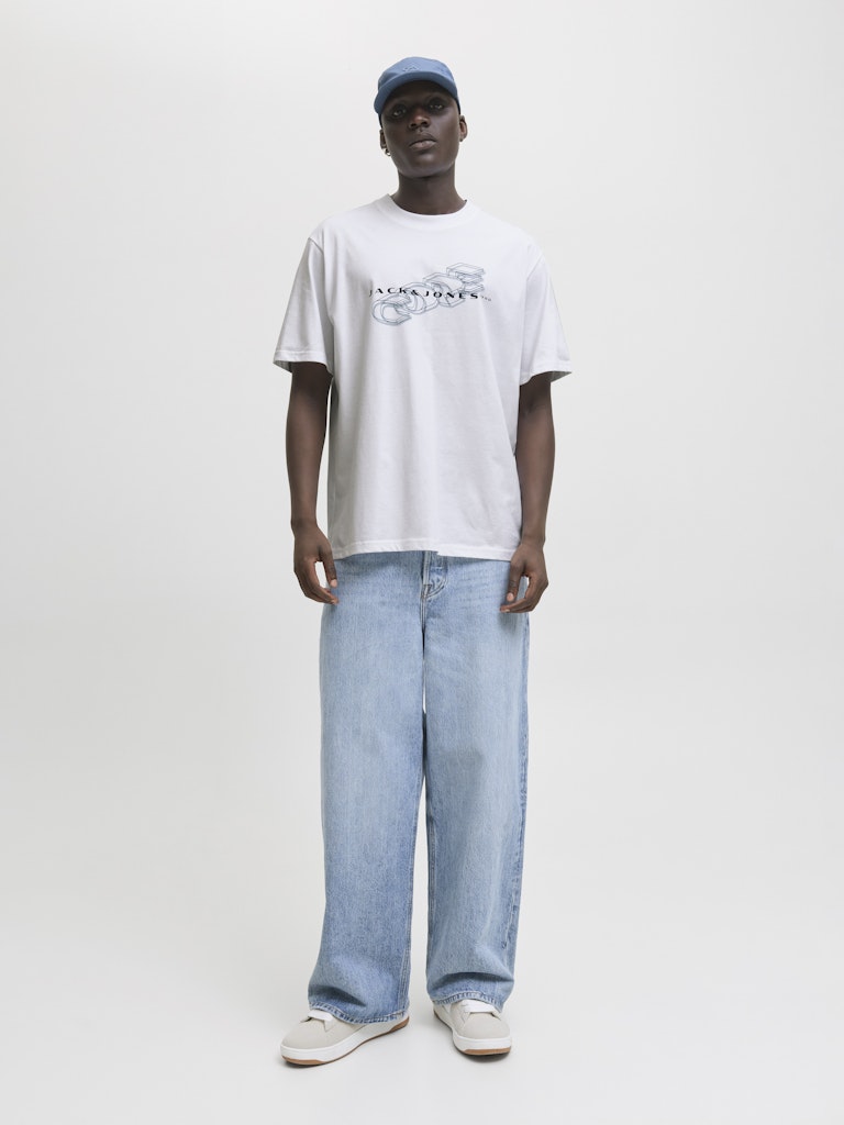 Person wearing a white t-shirt and blue jeans on a plain background