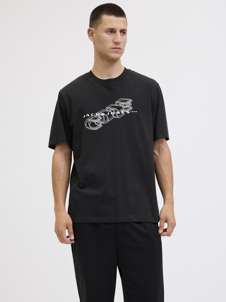 Man wearing a black t-shirt with a logo on a white background