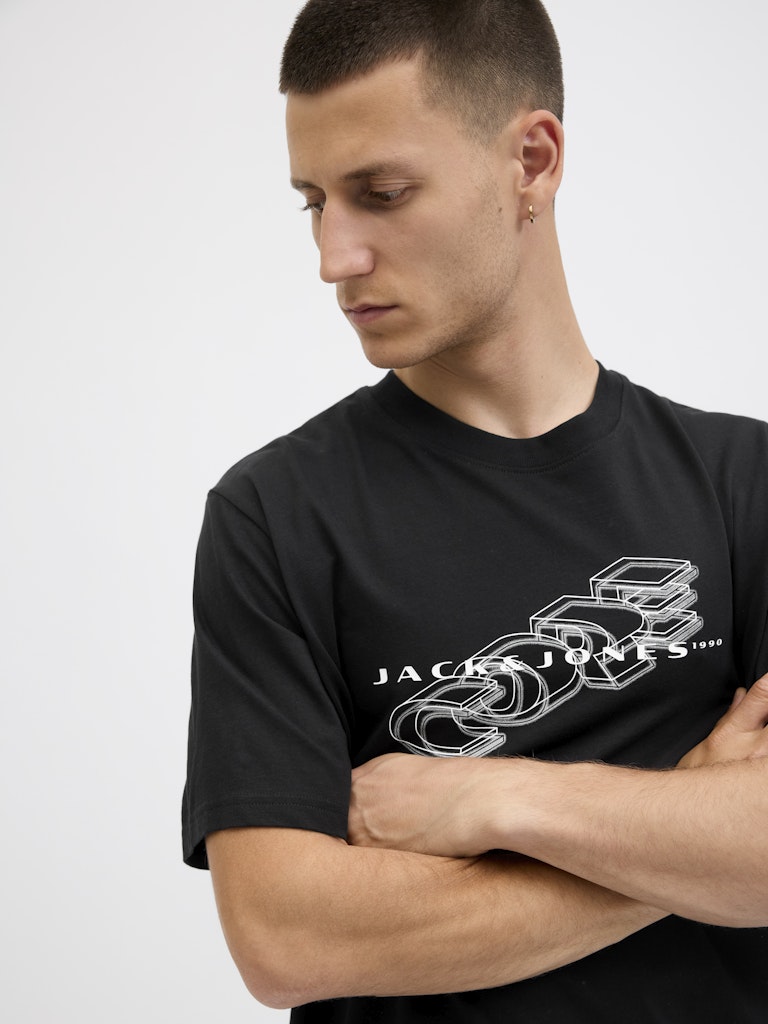 Man wearing a black t-shirt with a logo on a white background