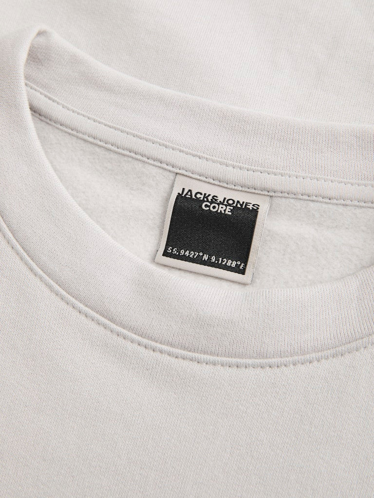 Close-up of a gray sweatshirt with a brand label on the collar.