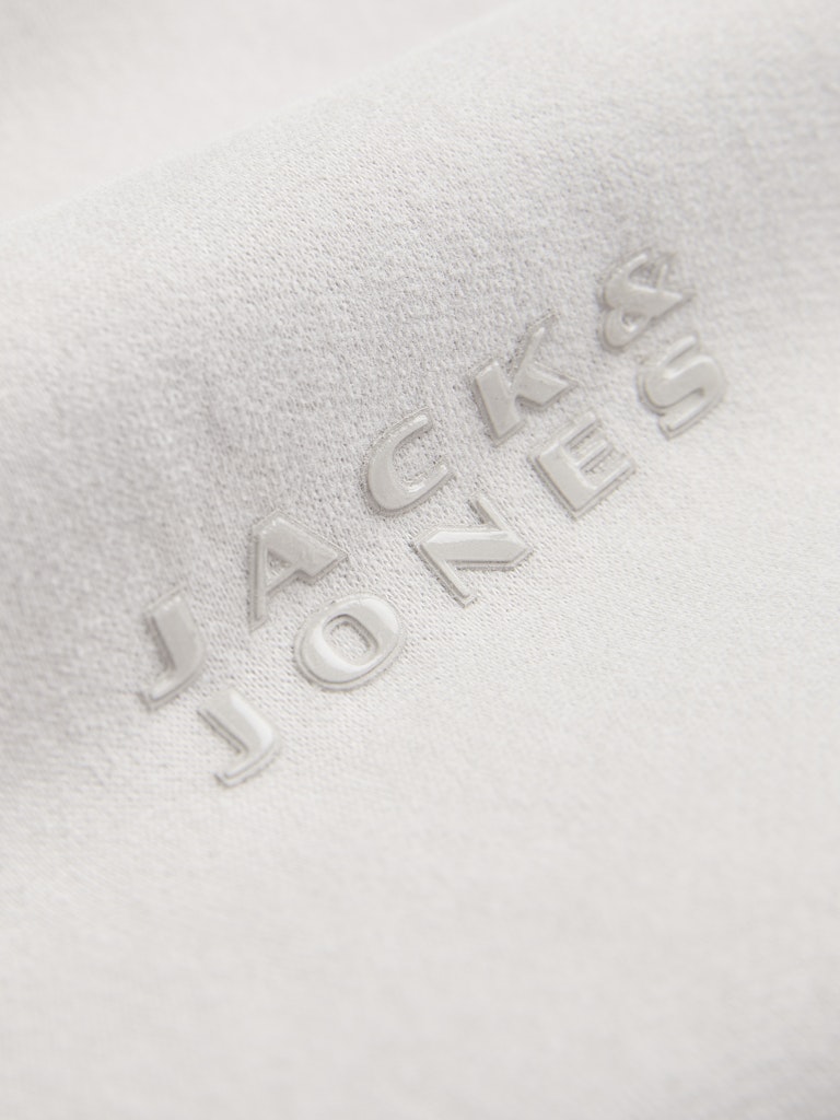 Close-up of 'Jack & Jones' logo on a textured white surface