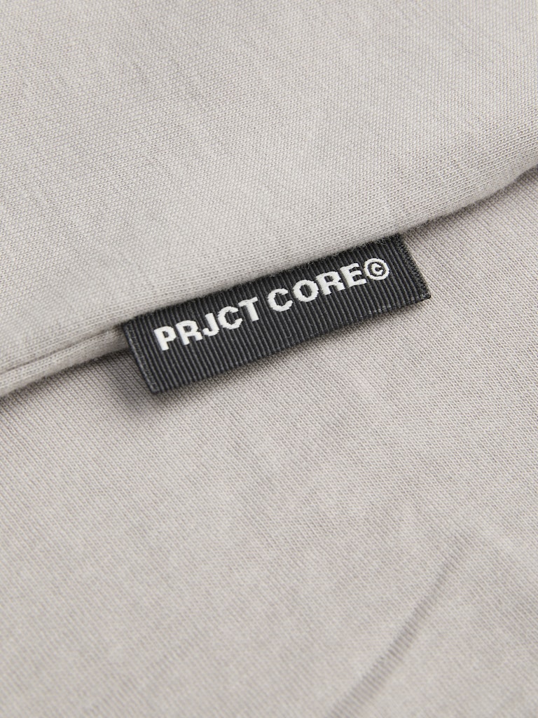 PRJCT CORE label on a beige fabric background