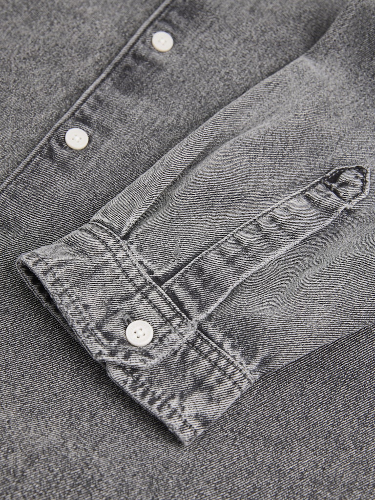 Close-up of a gray denim shirt with button details