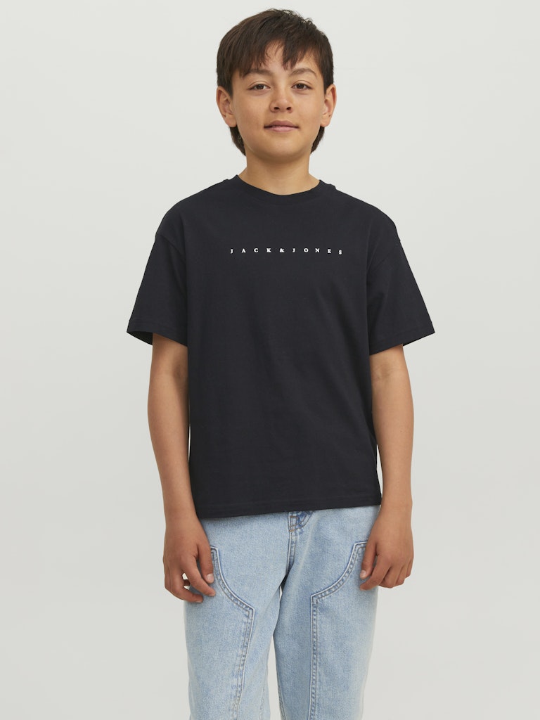 Child wearing a black t-shirt with text on a plain background