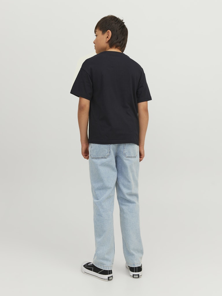 Child wearing a black t-shirt and light blue jeans on a white background
