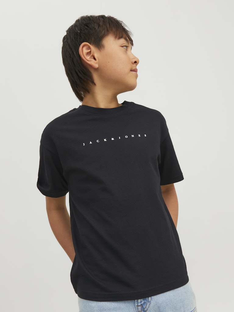 Person wearing a black t-shirt with text on a plain background