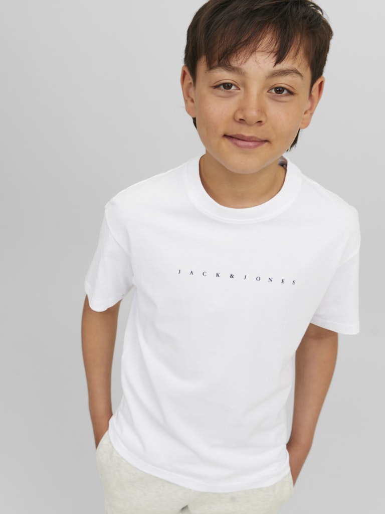 Child wearing a white t-shirt with 'Jack & Jones' logo on a gray background