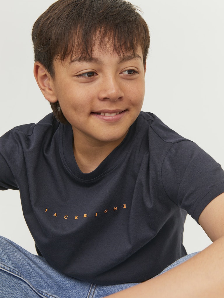 Child wearing a navy blue t-shirt with 'Jack & Jones' logo on a light gray background