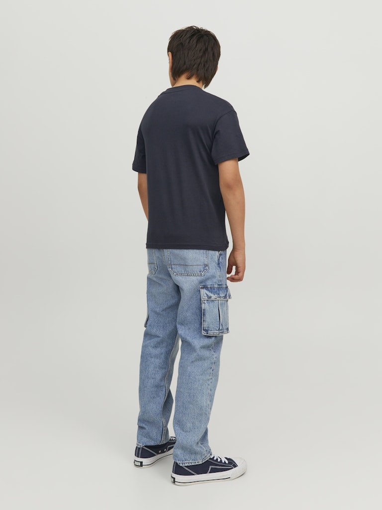 Person wearing a navy t-shirt and light blue cargo pants on a white background