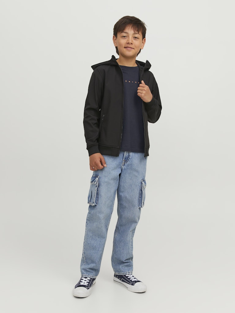 Child wearing a black jacket, navy t-shirt, and blue jeans on a light gray background
