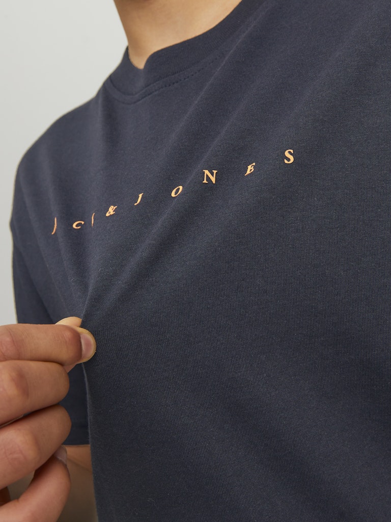 Navy blue t-shirt with gold logo on a plain background