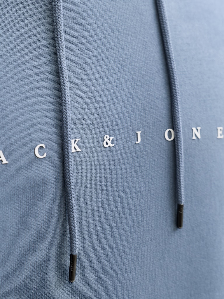 Close-up of a blue hoodie with 'Jack & Jones' branding on the hood.