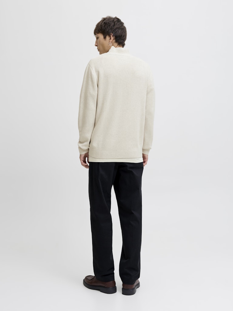 Person wearing a beige half-zip sweater against a plain background-Back view