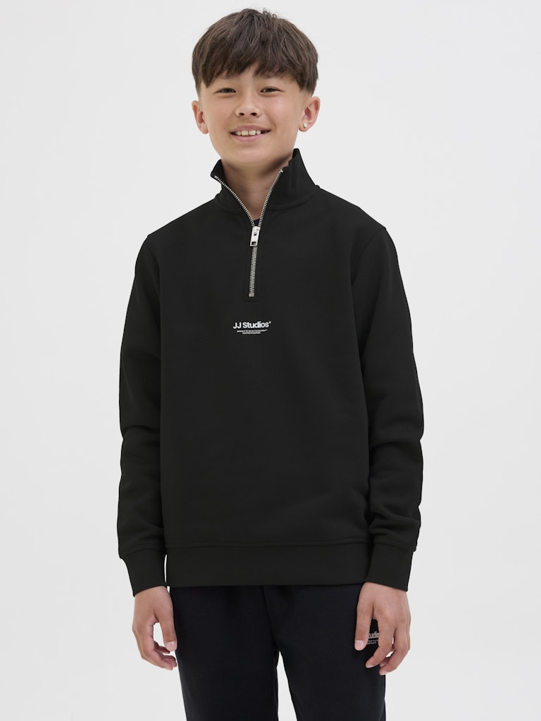 Child wearing a black half-zip sweatshirt with a logo on a white background