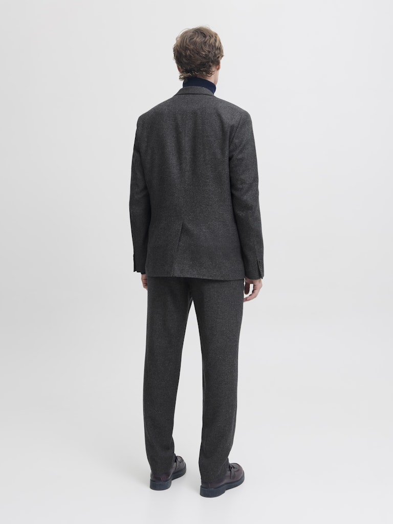 Man wearing a navy tweed look blazer from behind