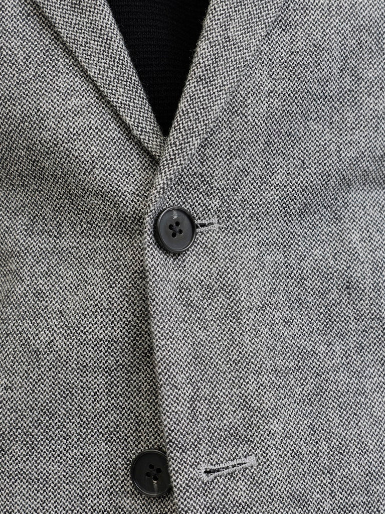 Close-up of a gray textured fabric with buttons