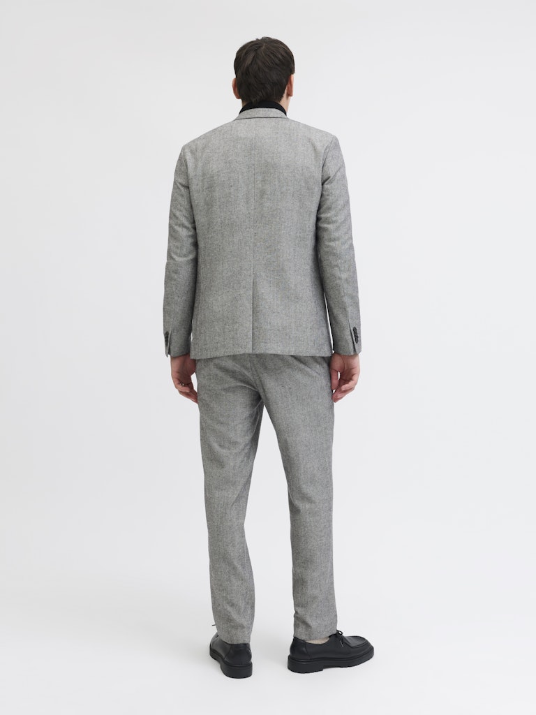 Man wearing a gray suit on a white background