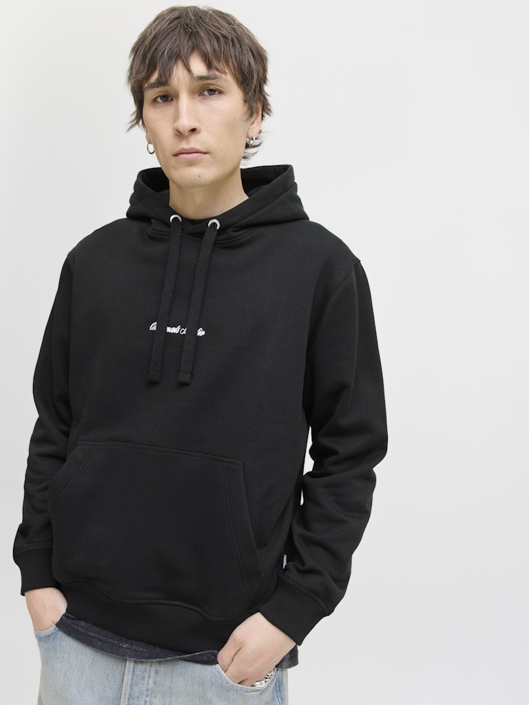 Person wearing a black hoodie on a plain background