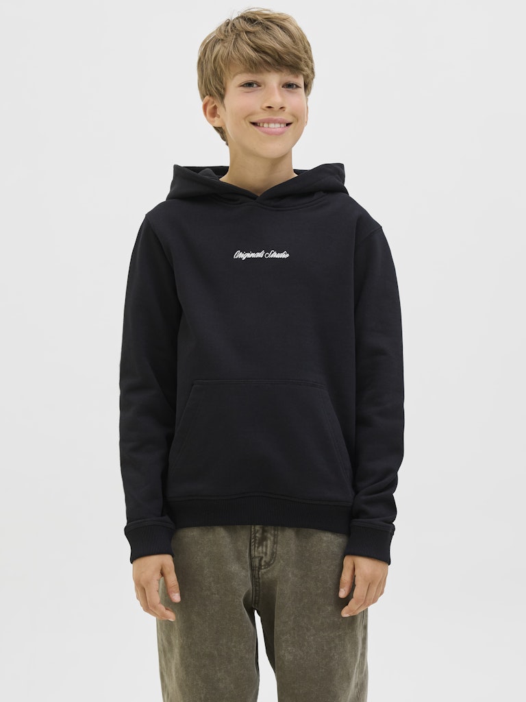 Young boy wearing a black hoodie with text on a white background