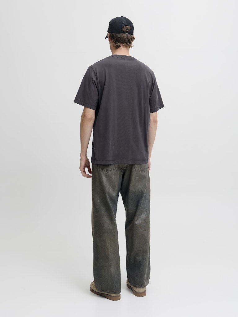 Person wearing a dark gray t-shirt and pants on a white background