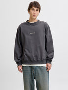 Man wearing a grey sweatshirt