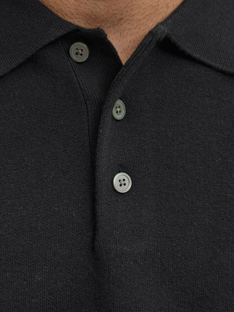 Close-up of a black polo shirt with buttons