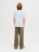 Person wearing a white t-shirt and brown pants on a plain background