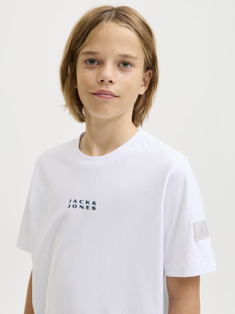 Child wearing a white 'Jack & Jones' t-shirt on a plain background
