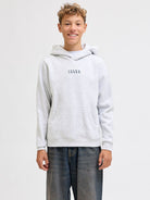 Person wearing a gray hoodie with 'Jack & Jones' logo on a white background